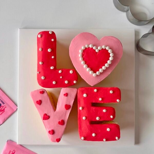 Heart-shaped Valentine’s Love Cake with cream and sugar flower decoration – Best Cake in Delhi NCR